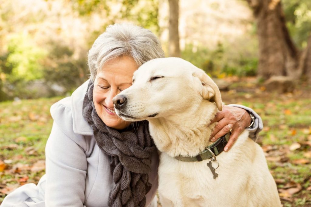 Senior lady with her pet in the park.